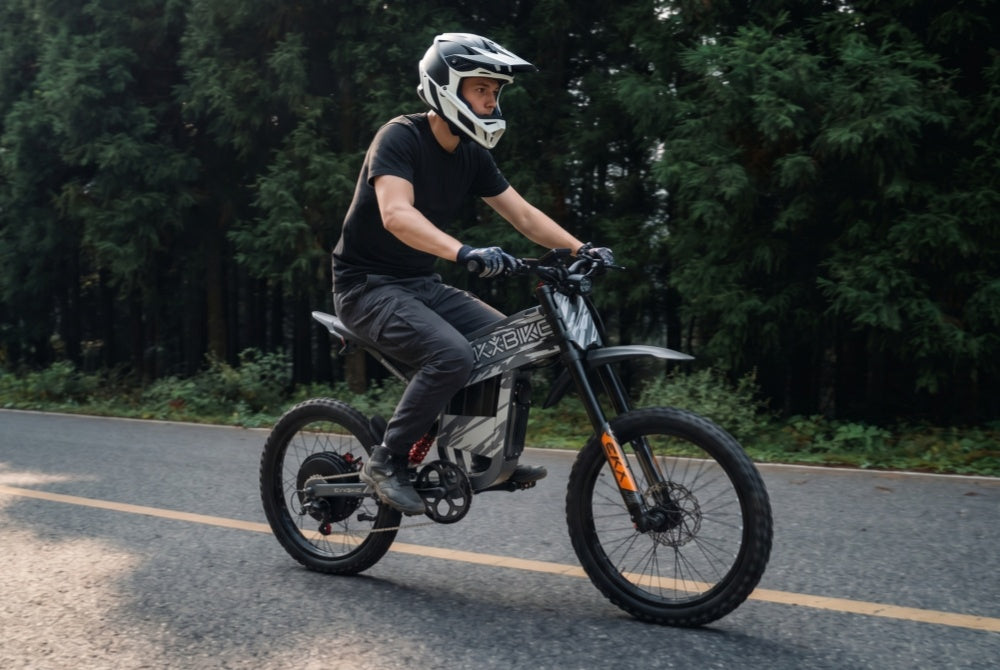Rider enjoying a smooth journey on the EKX TX1 60V ebike along a scenic path, powered by its high-capacity single battery for up to a 55-mile range.